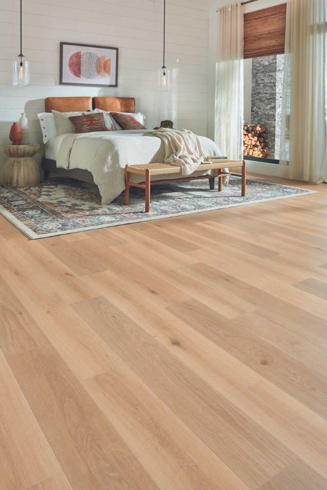 light white oak wood look laminate floors in earth toned modern bedroom with area rug